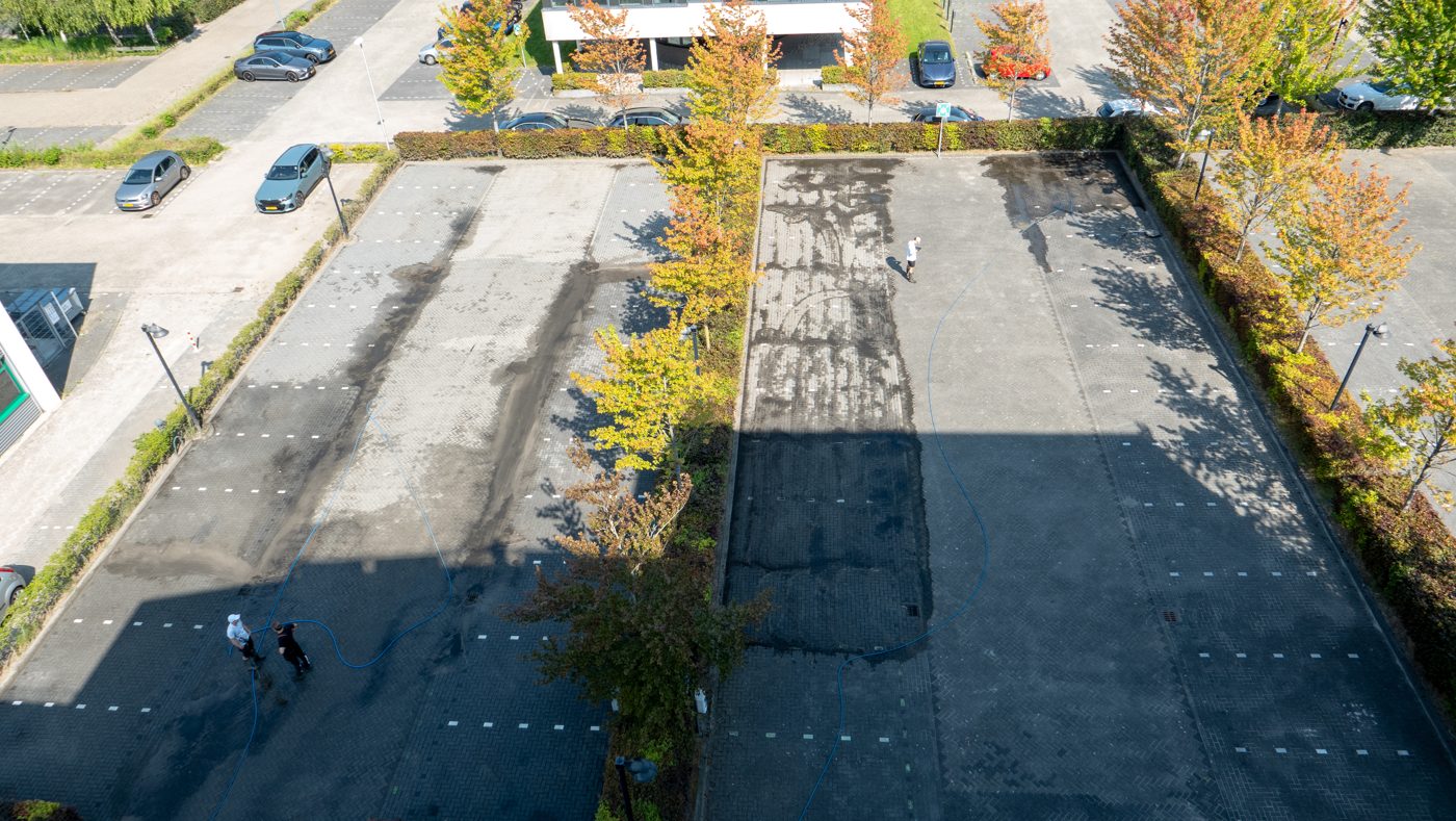 Aerial view of the parking terrain at Pulse being pressure washed, Almere